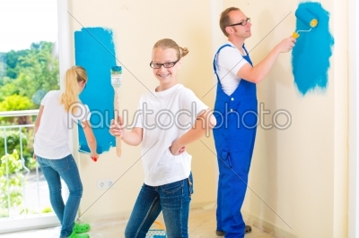 Father and Kids paint a wall in home