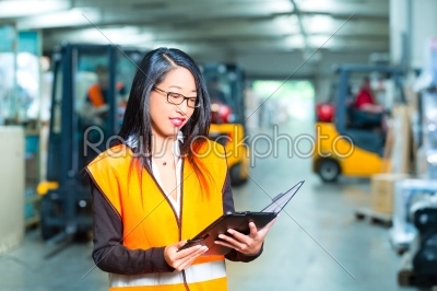 female employee or supervisor at warehouse