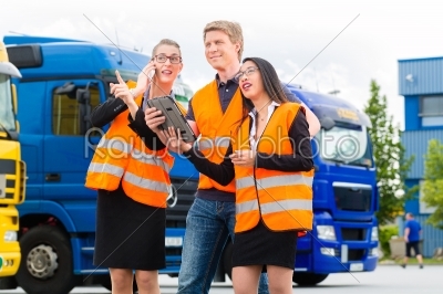 Forwarder in front of trucks on a depot