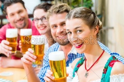friends drinking beer in Bavarian restaurant or pub