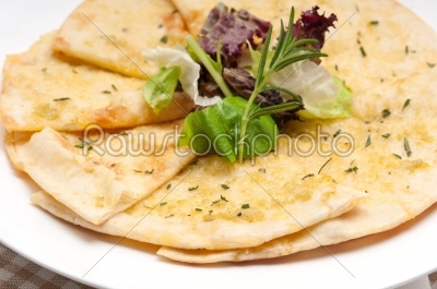 garlic pita bread pizza with salad on top