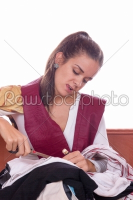 girl cutting fabric and clothes with scissors