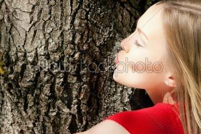 Girl kissing tree