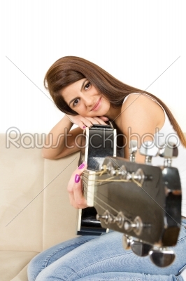 girl leaning her face on the guitar
