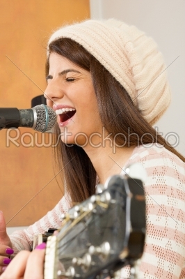 girl singing loud and playing guitar
