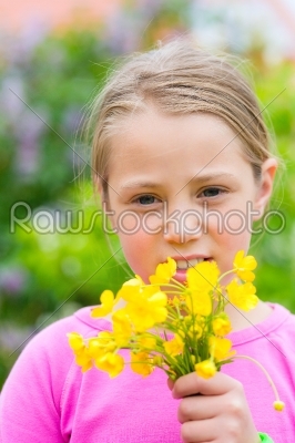 Girl with buttercups in summer