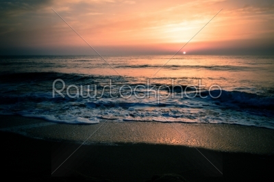 Golden sunrise sunset over the sea ocean waves