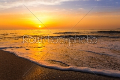 Golden sunrise sunset over the sea ocean waves