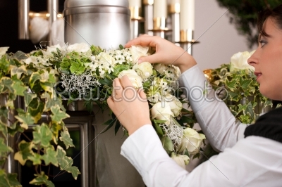 Grief - female mortician preparing urn Funeral 