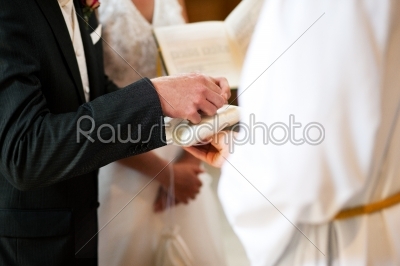 Groom taking rings in wedding ceremony