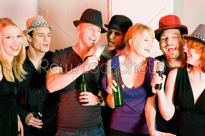 Group of friends at karaoke party