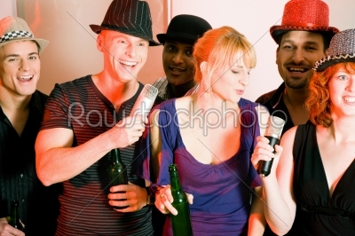 Group of friends at karaoke party