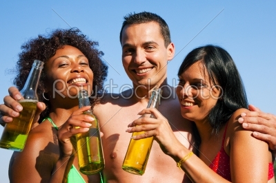 Group of friends drinking beer in swimwear