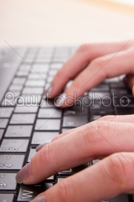 hands of business woman typing on laptop keyboard