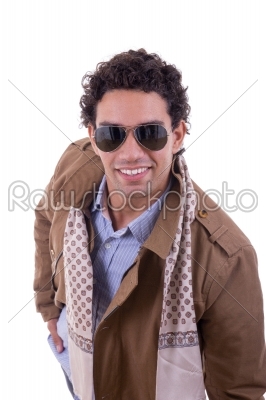 handsome fashion man with sunglasses wearing coat with a scarf