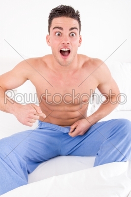 handsome half naked man having problems with genitals and potenc