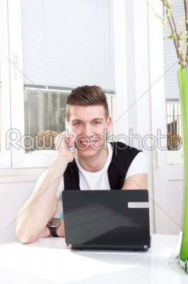handsome man using laptop and mobile