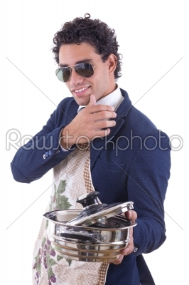 handsome man with an apron holding a cooking pot