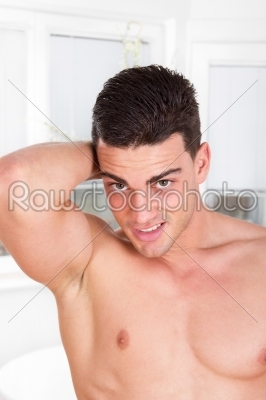 handsome sexy shirtless man with arm lifted behind his head