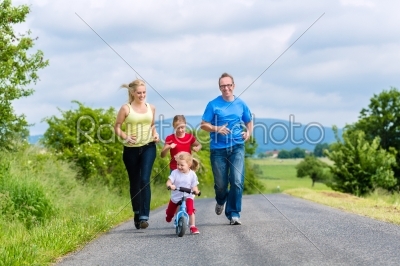 Happy family running for sport on street