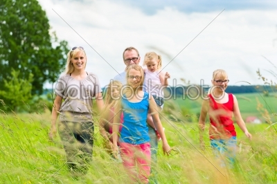 Happy Family walking in the meadow