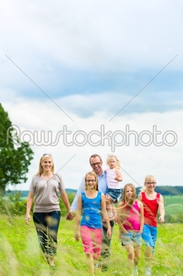 Happy Family walking in the meadow