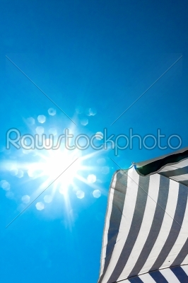 High resolution beach umbrella on blue sky background