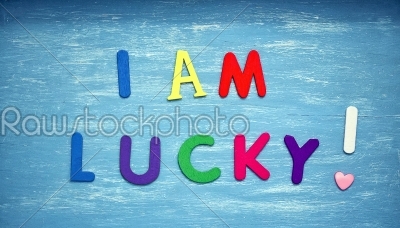 I am lucky written on a blue wood background