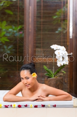 Indonesian woman having wellness bath in spa