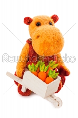 Isolated yellow hippo toy with the cart full of carrot
