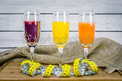 Juice with measure tape wooden table