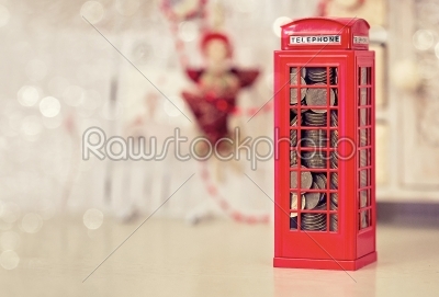 London telephone booth moneybox on wooden white table 