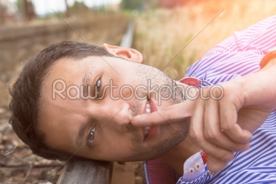 male model lying on the rail