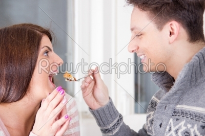 Man feeding woman with dessert