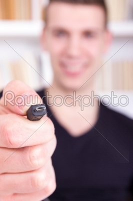 man holding and showing black micro USB cable