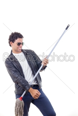 man in leather jacket playing on a broom
