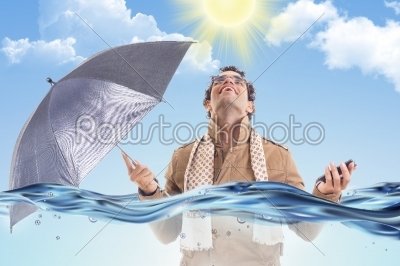 man in the coat in the water with an umbrella