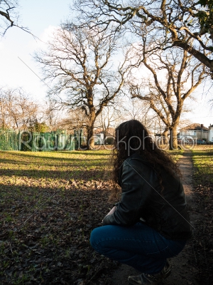 Man Kneeling in a Field