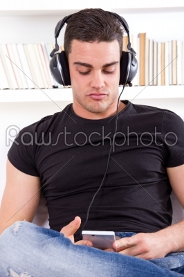 man listening music with headphone