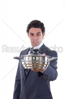 man looking at pot for cooking with expression