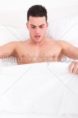 man looking down at his underwear at his penis