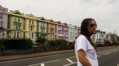 Man Standing in Front of a Row of Houses
