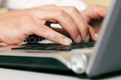 Man typing computer keyboard