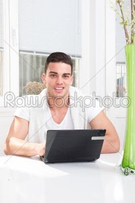 man using laptop on the table in the living room atmosphere