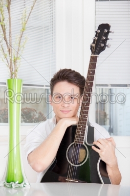 man with guitar at home