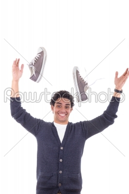 man with sneakers throwing them away