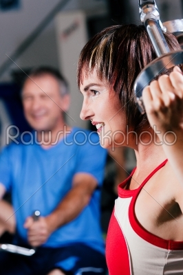 Mature woman exercising in gym