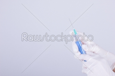 medical gloves and syringe with needle