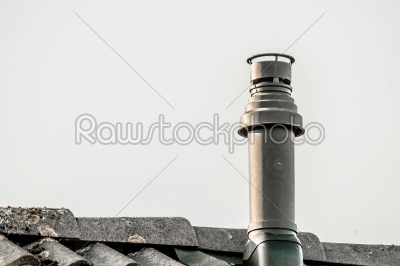 Metal chimney on the top a roof