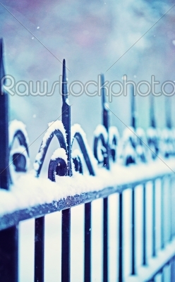 metal decorative fence fragment with snow